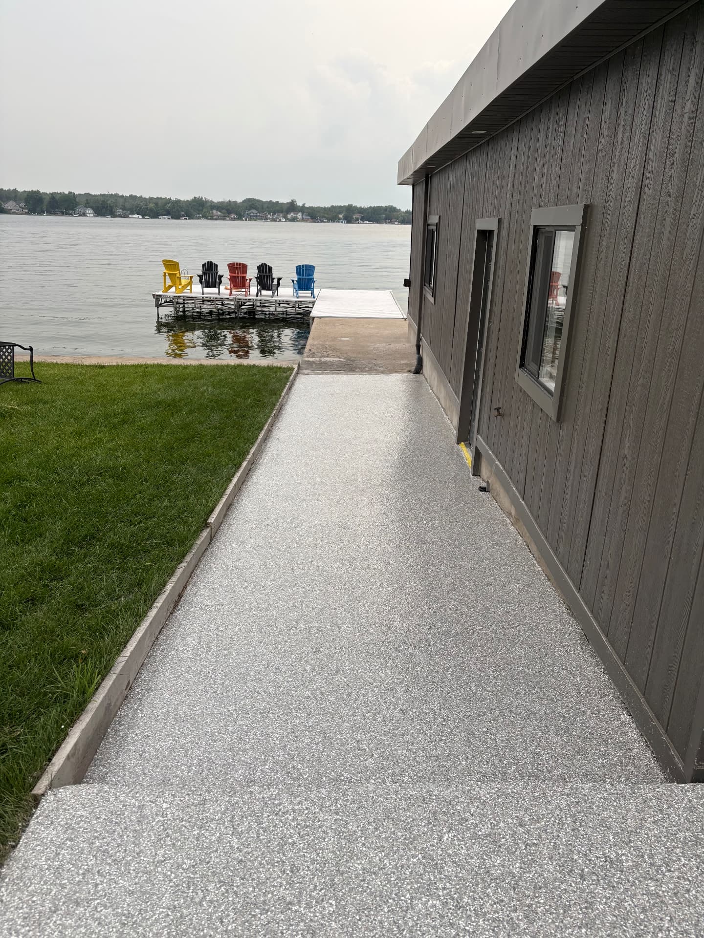Flake epoxy walkway beside a lakeside home